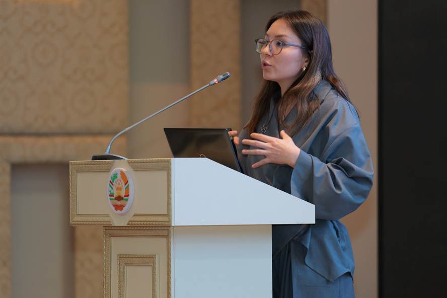 A person standing at a podium speaking into a microphone AI-generated content may be incorrect.