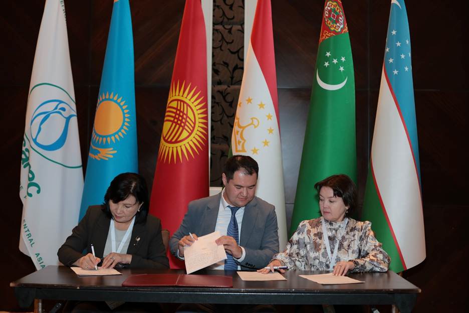 A group of people signing papers AI-generated content may be incorrect.